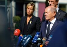 What are the risks of Scholz’s position regarding German aid to Ukraine?